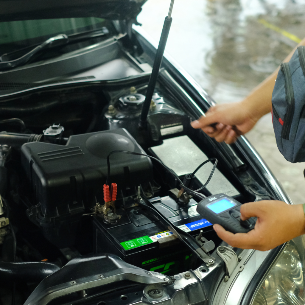 Seseorang sedang cek aki mobil